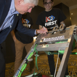 Michigan Gov. Rick Snyder signs a Detroit-based FIRST team's robot during a press event to announce the arrival of FIRST Championship in Detroit starting in 2018. (Photo: Business Wire) 