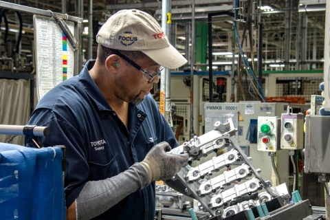 Henry "Sonny" Smith, a Toyota West Virginia team member for 17 years, inspects the cam housing on a four-cylinder engine. (Photo: Business Wire)