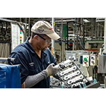 Henry "Sonny" Smith, a Toyota West Virginia team member for 17 years, inspects the cam housing on a four-cylinder engine. (Photo: Business Wire)