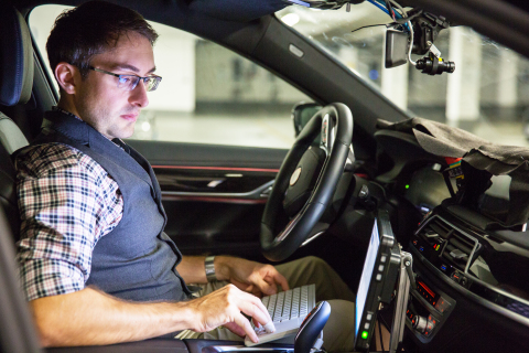 BMW engineer André Mueller tests autonomous driving technology in a BMW autonomous test car. (CREDIT: BMW Group)