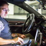 BMW engineer André Mueller tests autonomous driving technology in a BMW autonomous test car. (CREDIT: BMW Group)